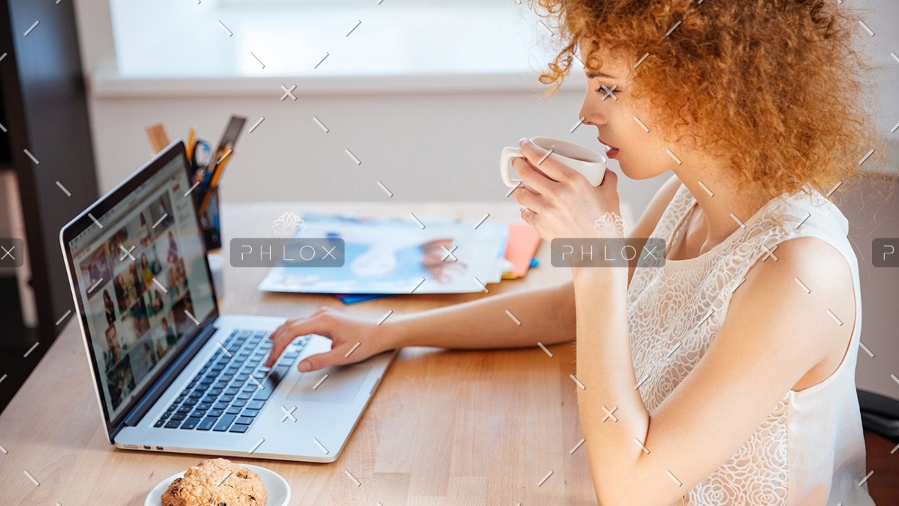 demo-attachment-177-woman-photographer-drinking-coffee-and-working-PJNBP6U